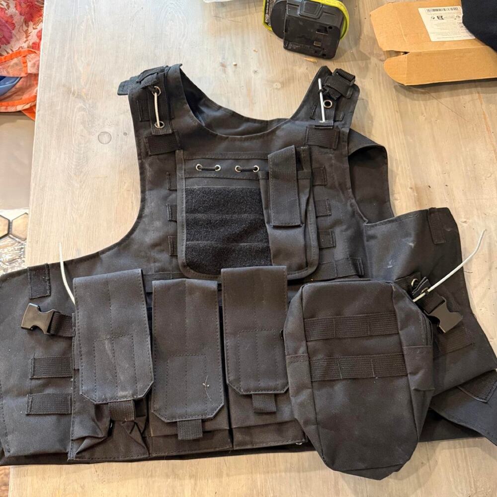 Black tactical vest with multiple pockets